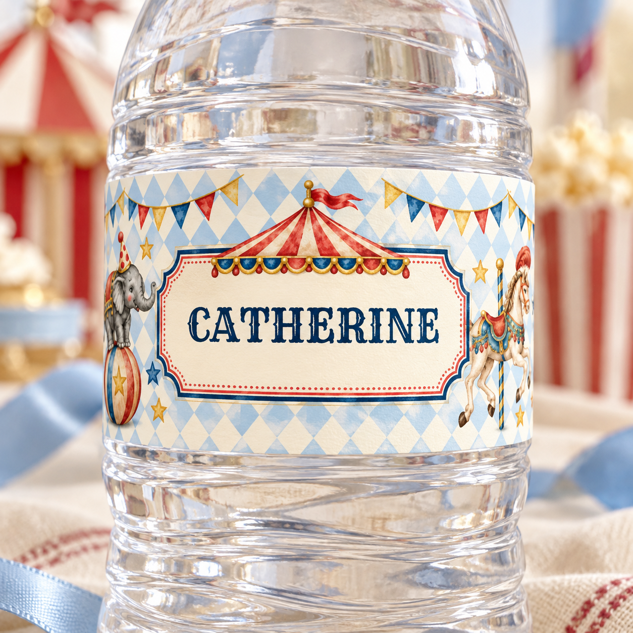 Close-up of a circus water bottle label reading “Catherine,” showing the cream name panel, decorative border and blue diamond pattern.
