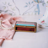 Vintage Via Vermont glass jewelry box with handmade Mexican design on a white countertop.