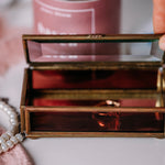 Close-up of vintage Via Vermont glass jewelry box with colorful Mexican pattern on white counter.