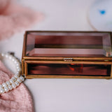 Collectible vintage glass trinket box by Via Vermont, displayed on a white bathroom counter.