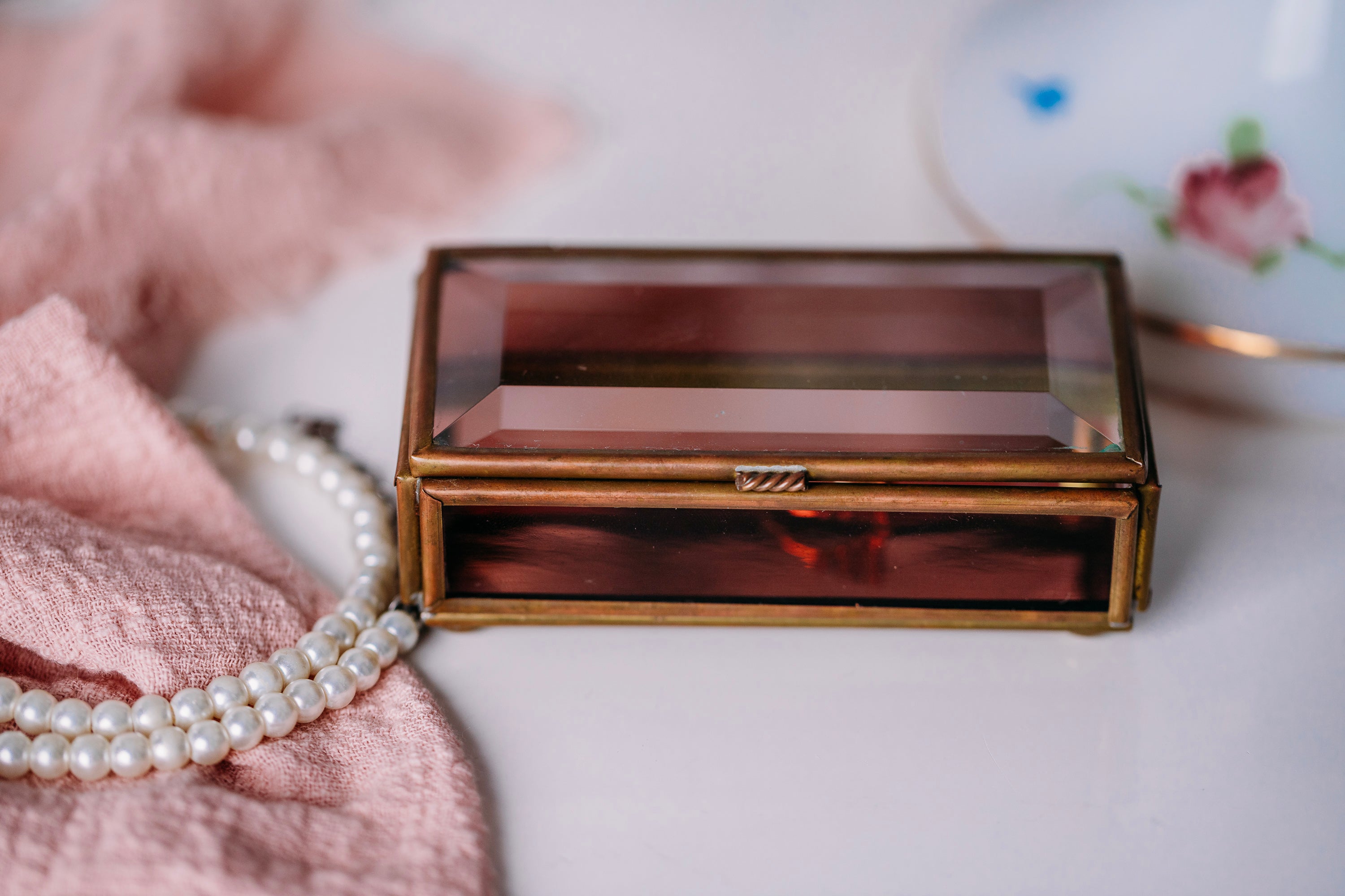 Collectible vintage glass trinket box by Via Vermont, displayed on a white bathroom counter.