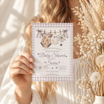 Hand holding a Little Boo girl baby shower invitation template with lavender Halloween details