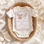 Editable Halloween baby shower invite shown with a baby onesie in a neutral basket