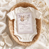 Editable Halloween baby shower invite shown with a baby onesie in a neutral basket