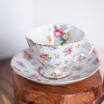 Vintage Hammersley floral chintz teacup and saucer made in England on wooden surface