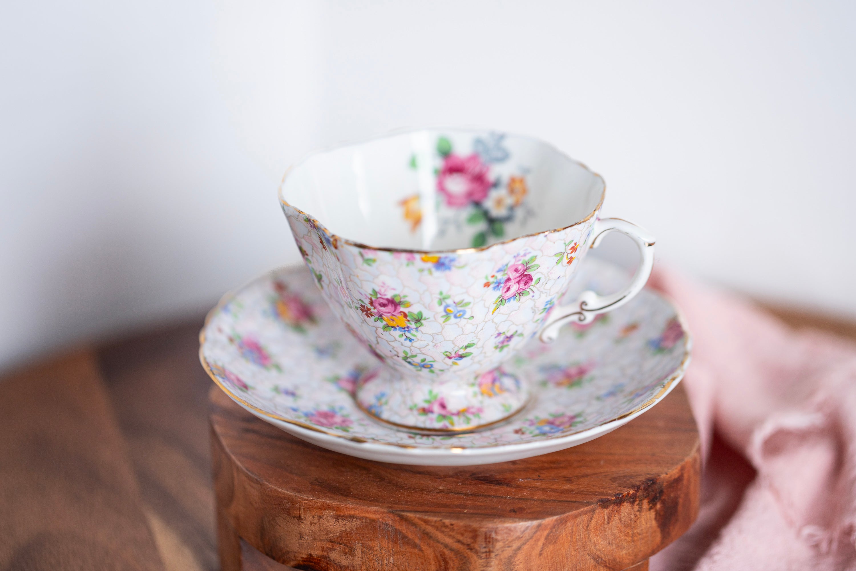 Vintage Hammersley floral chintz teacup and saucer made in England on wooden surface
