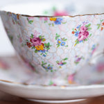English bone china teacup with pink floral chintz pattern and gold trim
