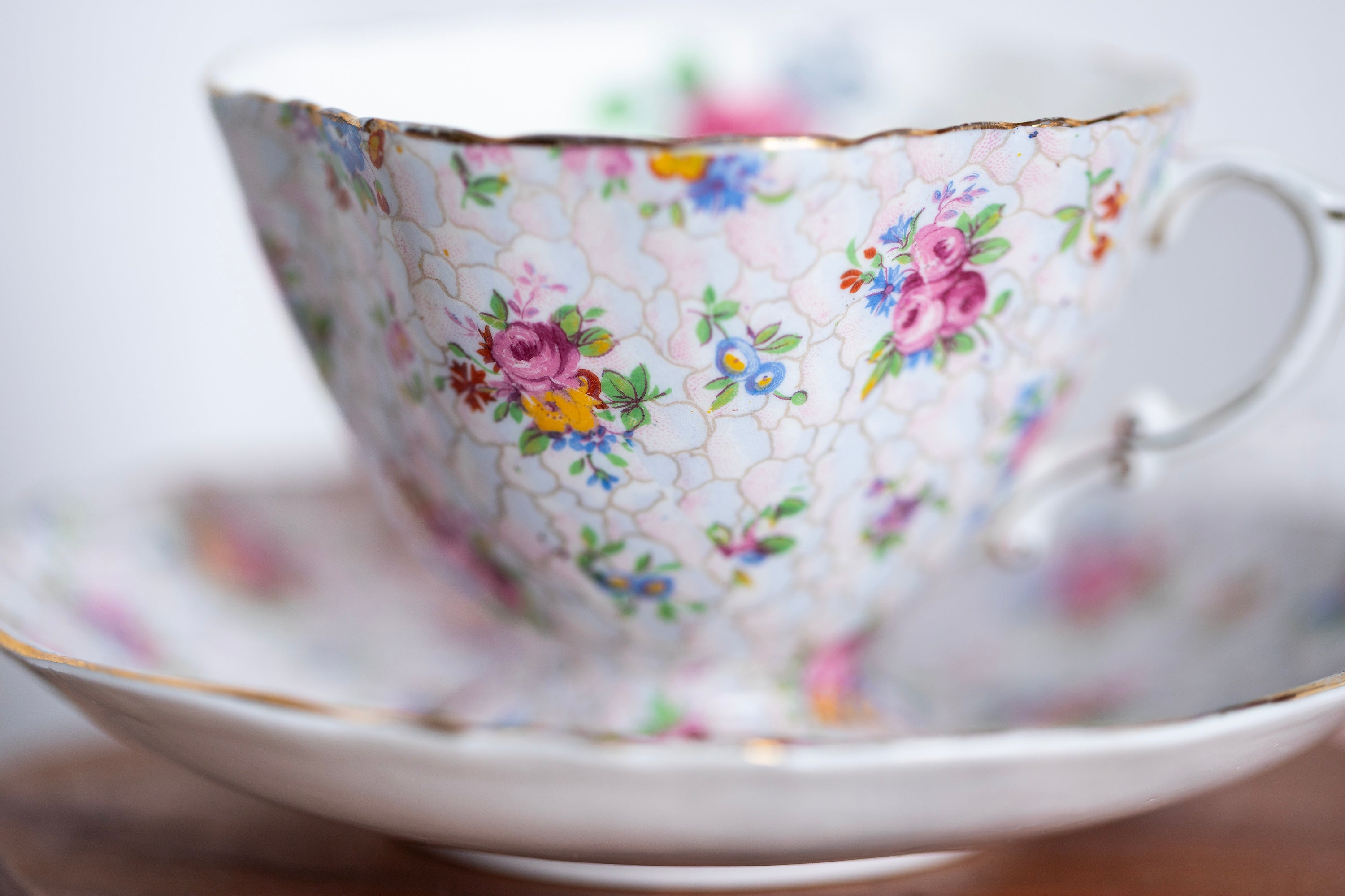 English bone china teacup with pink floral chintz pattern and gold trim