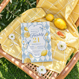 Freshly 21 lemon 21st birthday invitation styled on a sunny outdoor picnic blanket with flowers and citrus
