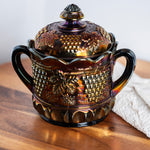 Antique Northwood carnival glass biscuit jar in electric amethyst purple with grape and cable pattern