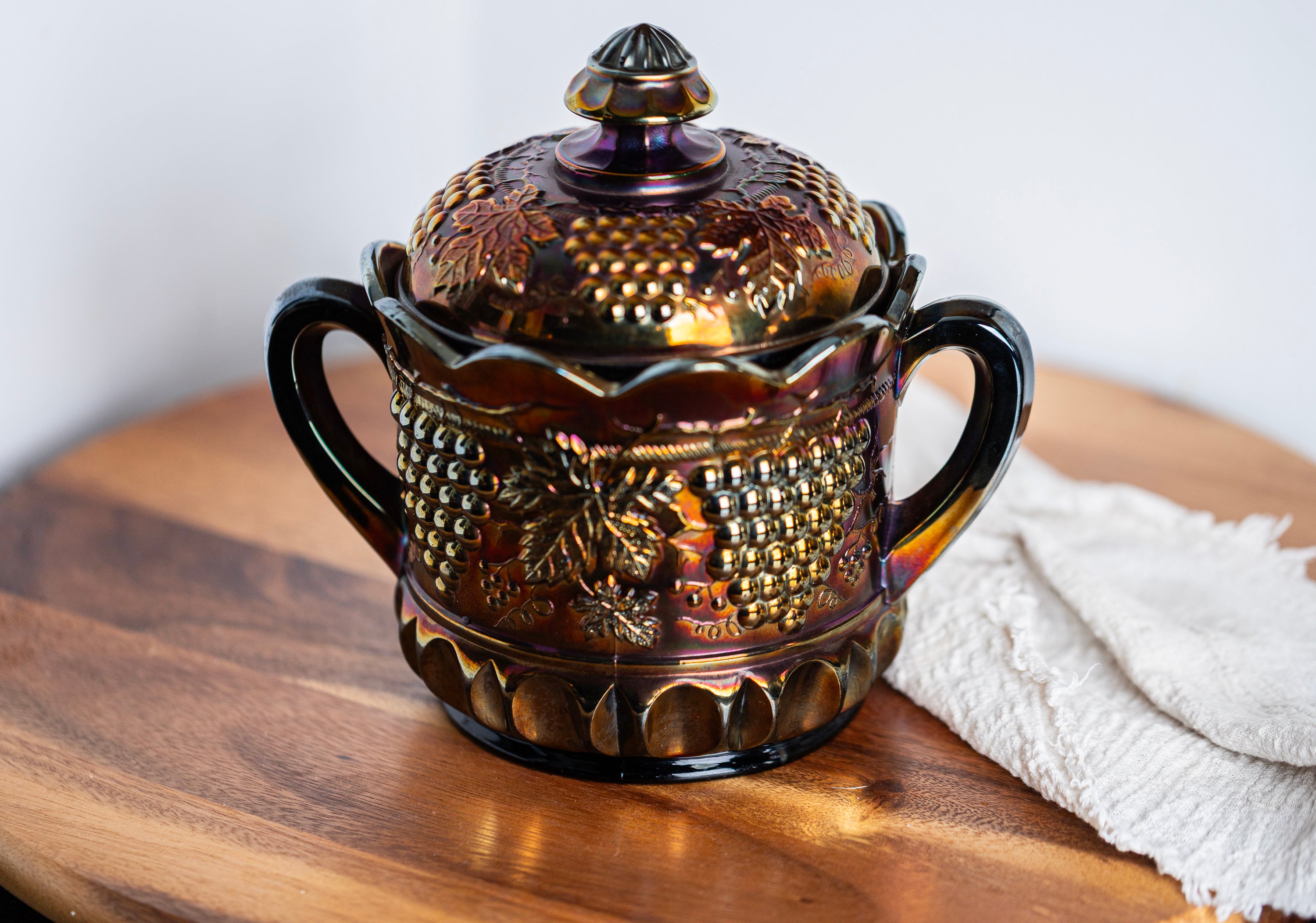Antique Northwood carnival glass biscuit jar in electric amethyst purple with grape and cable pattern