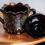 Collectible Northwood carnival glass covered candy dish in rich purple tones