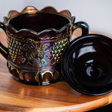 Collectible Northwood carnival glass covered candy dish in rich purple tones