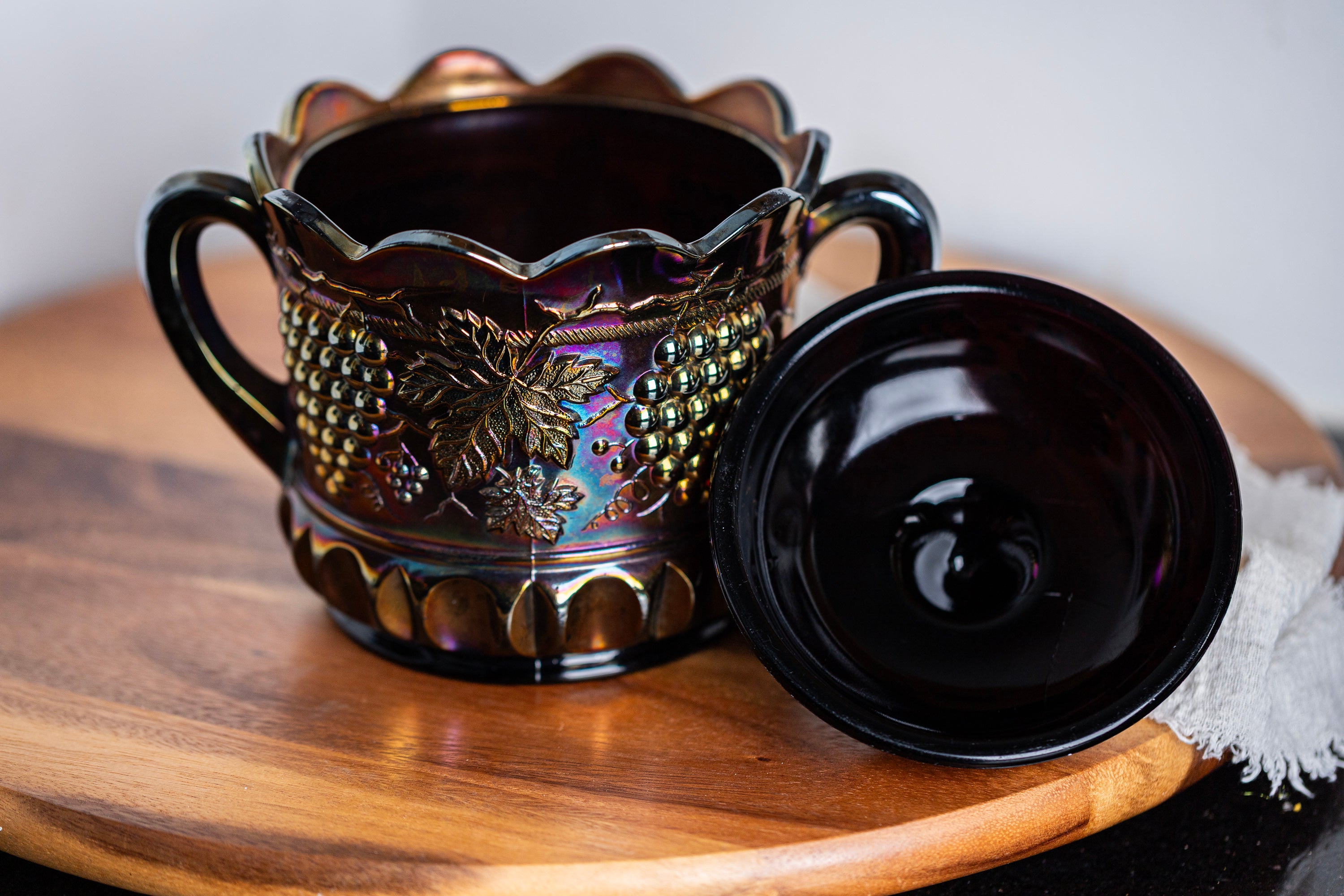Collectible Northwood carnival glass covered candy dish in rich purple tones