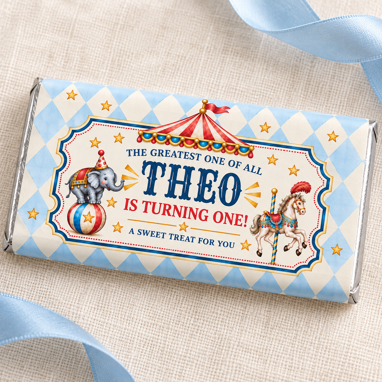 Close-up of Theo’s circus chocolate wrapper showing an elephant, carousel horse, red tent and blue diamond border.