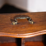 Wooden box with a decorative handle on a plain background