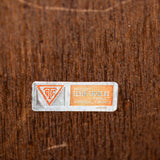 Small label with text and symbols on a textured brown background