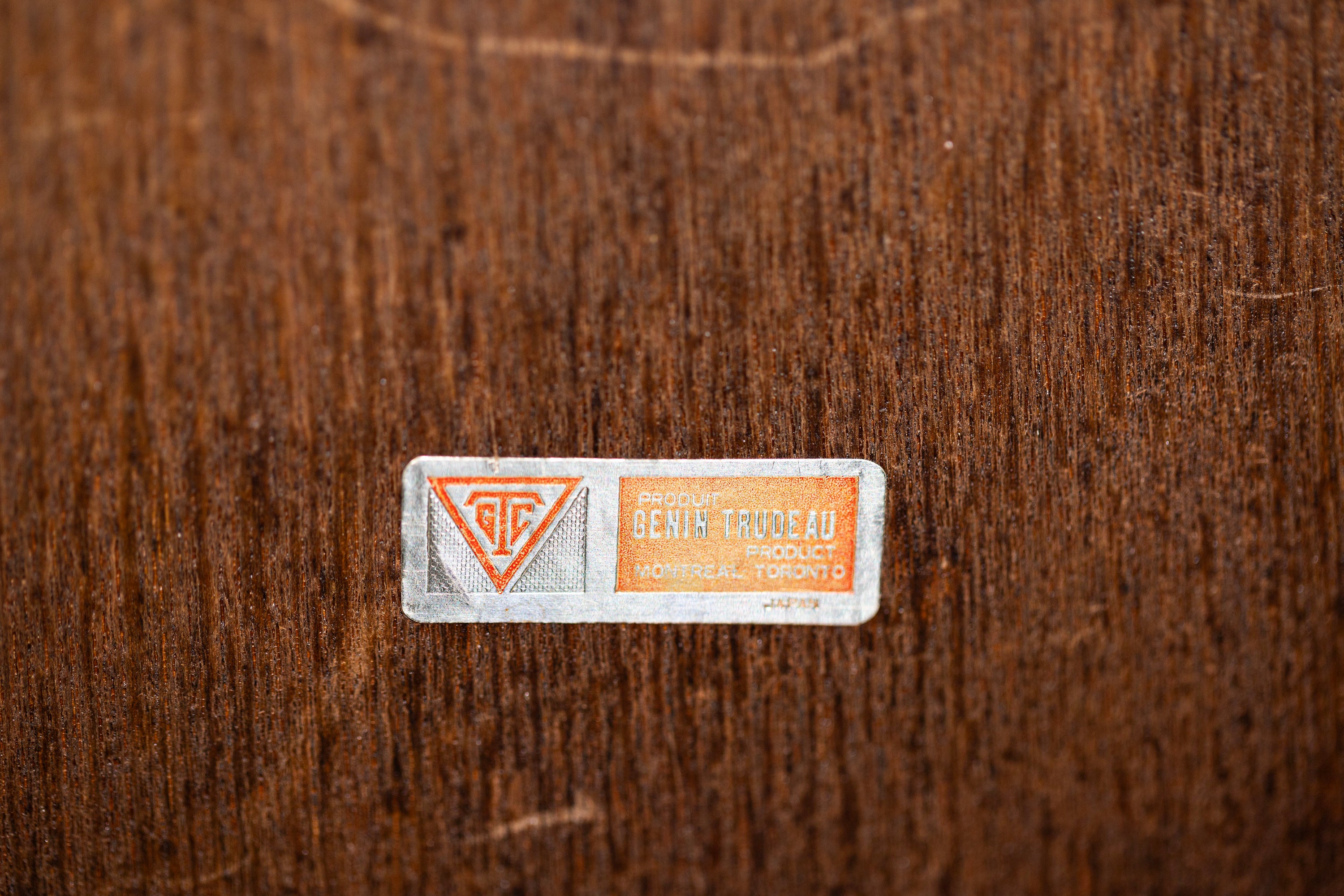 Small label with text and symbols on a textured brown background