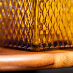 Close-up of a textured glass container on a wooden surface