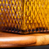 Close-up of a textured glass container on a wooden surface