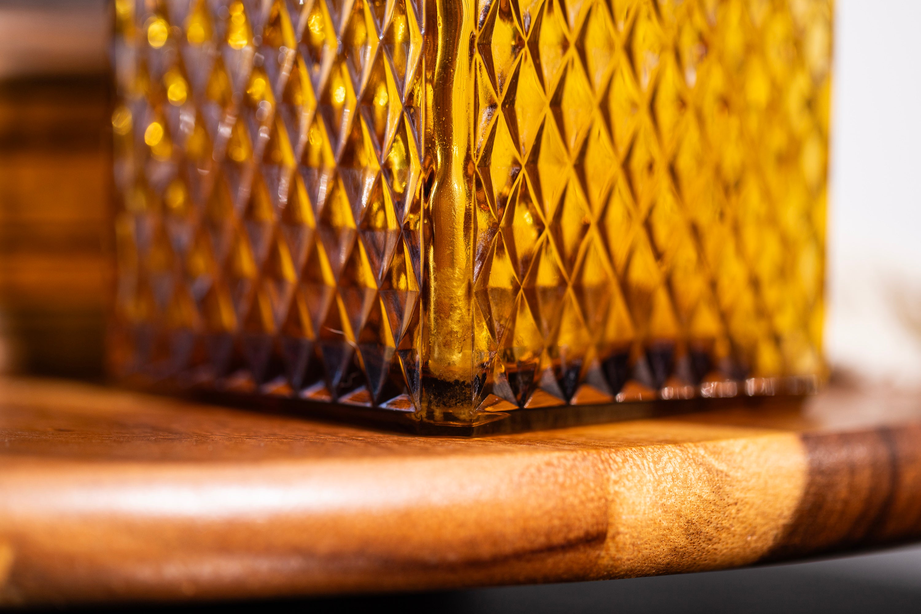 Close-up of a textured glass container on a wooden surface