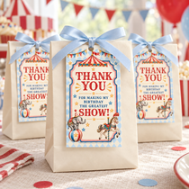 Vintage circus birthday thank you tags attached to ivory favor bags with pale blue ribbon bows.
