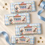 Four chocolate bars with blue diamond circus wrappers and personalized birthday text, arranged beside blue ribbon and gold stars.