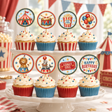 Eight cupcakes on a two-tier ivory stand with circus tent, drum, popcorn, balloon, lion, seal, ticket, and birthday toppers.