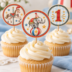 Close-up of a printed elephant cupcake topper, with carousel horse and number one toppers on cupcakes behind it.