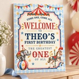 Theo’s circus birthday welcome sign with an elephant, carousel horse and blue diamond border, displayed on a wooden console.