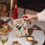 Christmas cocktail party invitation template shown in a festive holiday table setting.