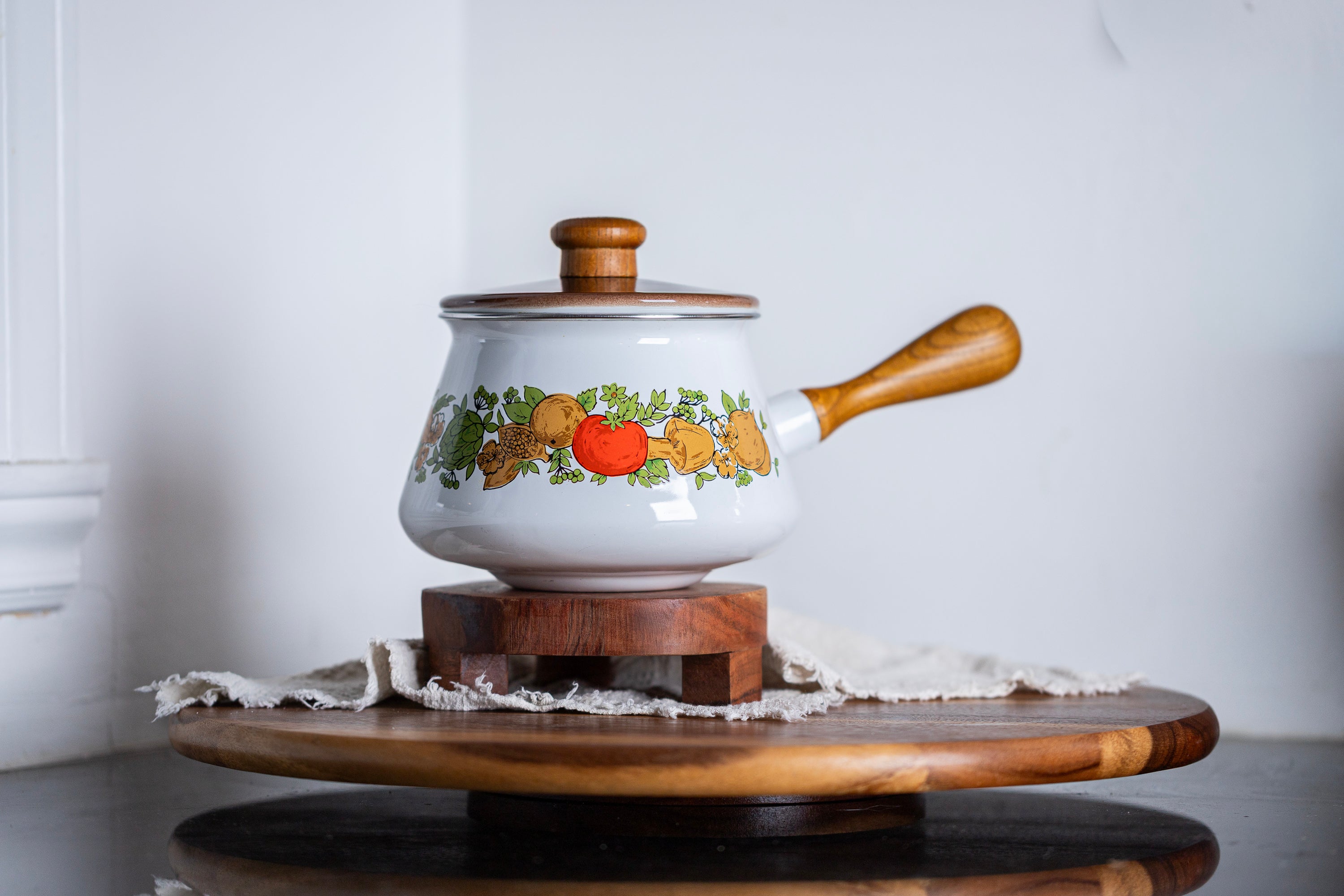 Floral enamel pot styled on rustic wooden tray