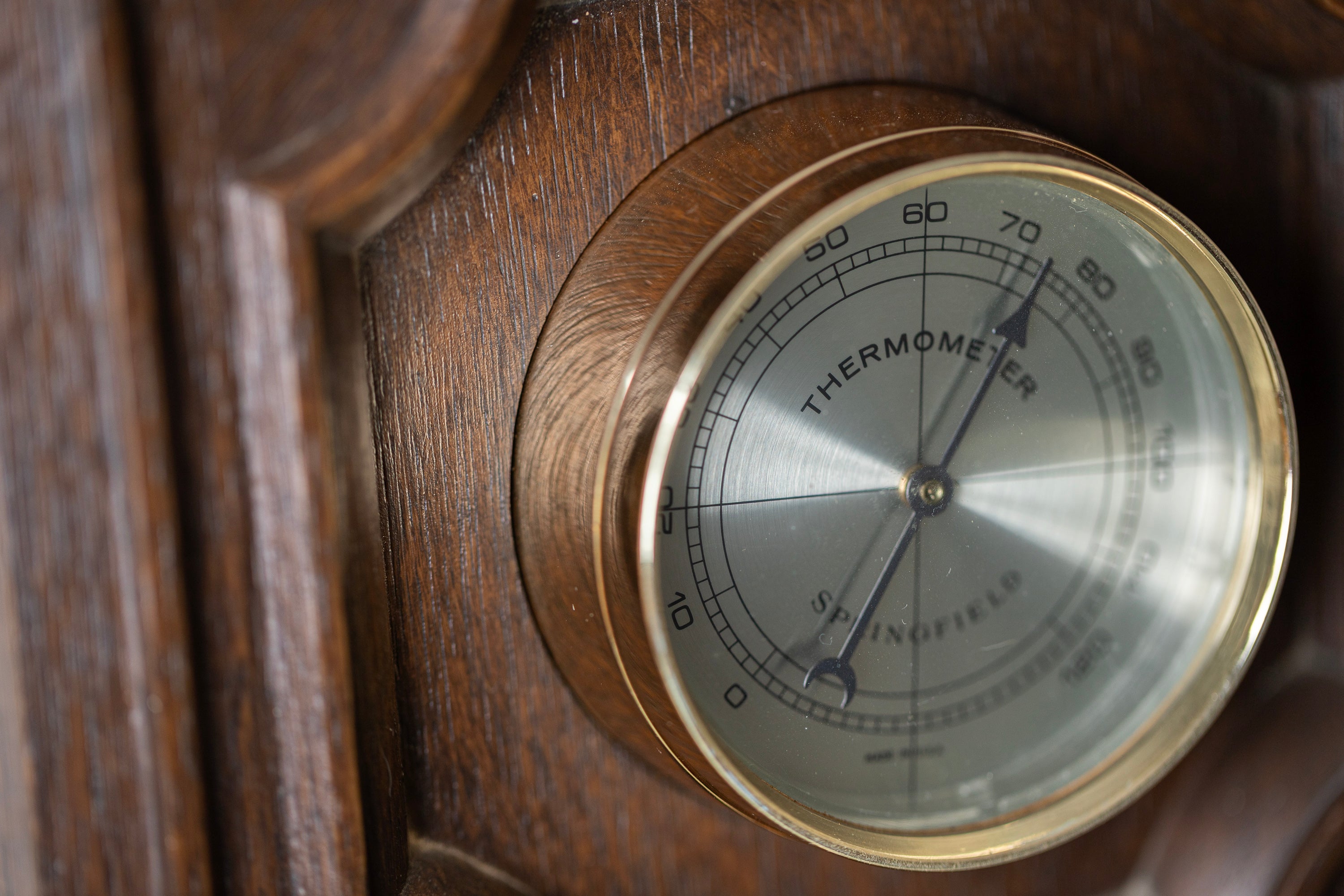 THERMOMETER BAROMETER on wooden background