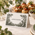 Woodland wedding food tent labeled Appetizers, standing beside a buffet platter with its folded back visible.